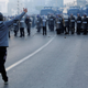 A protester confronts police, who used tear gas to disperse crowds as people marched to protest against president Bouteflika, in Algiers, Algeria, Feb. 22, 2019.
